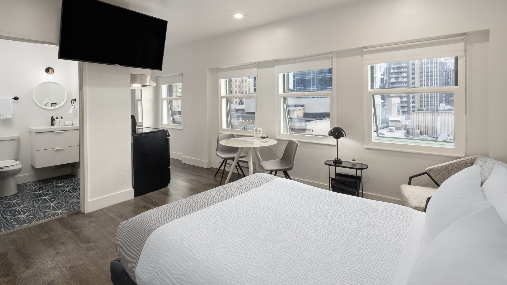 a room with a bed and a table and chairs