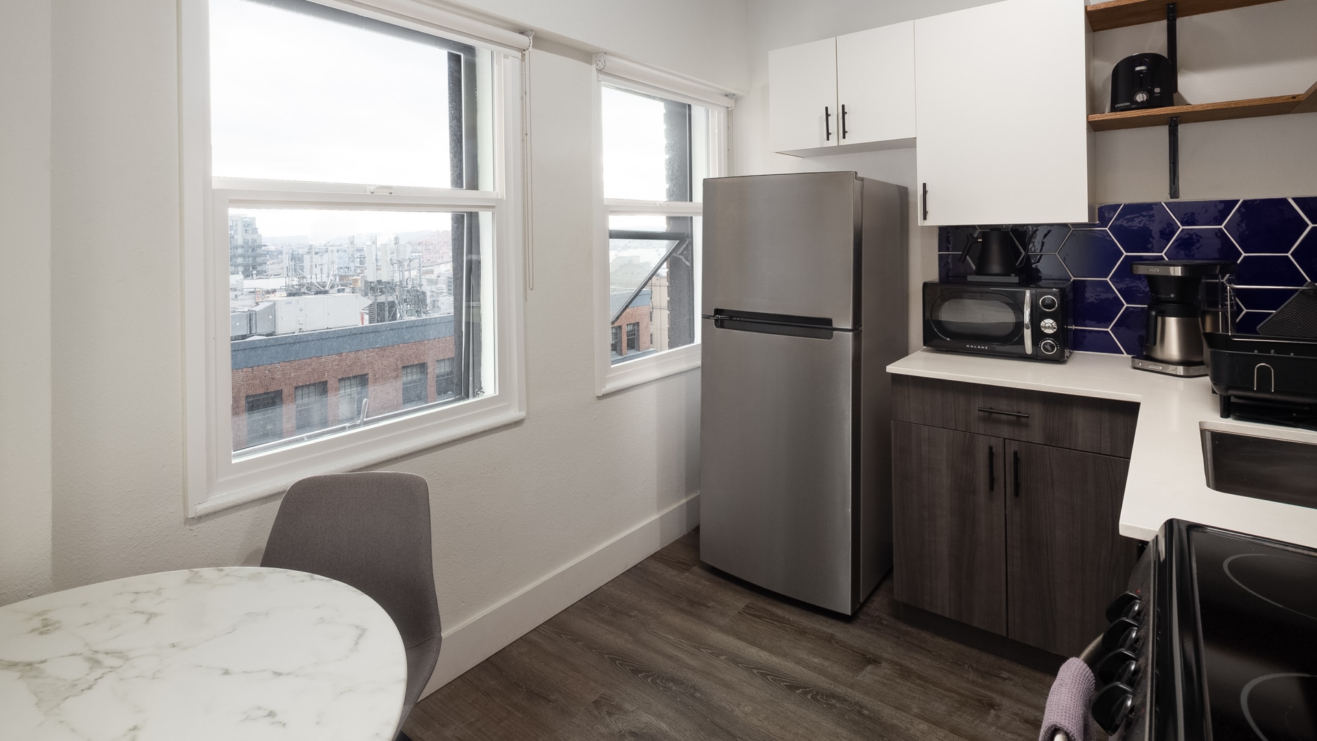 a kitchen with a table and a refrigerator