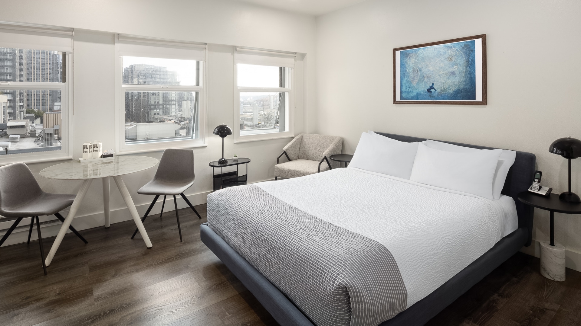 a bedroom with a bed and chairs
