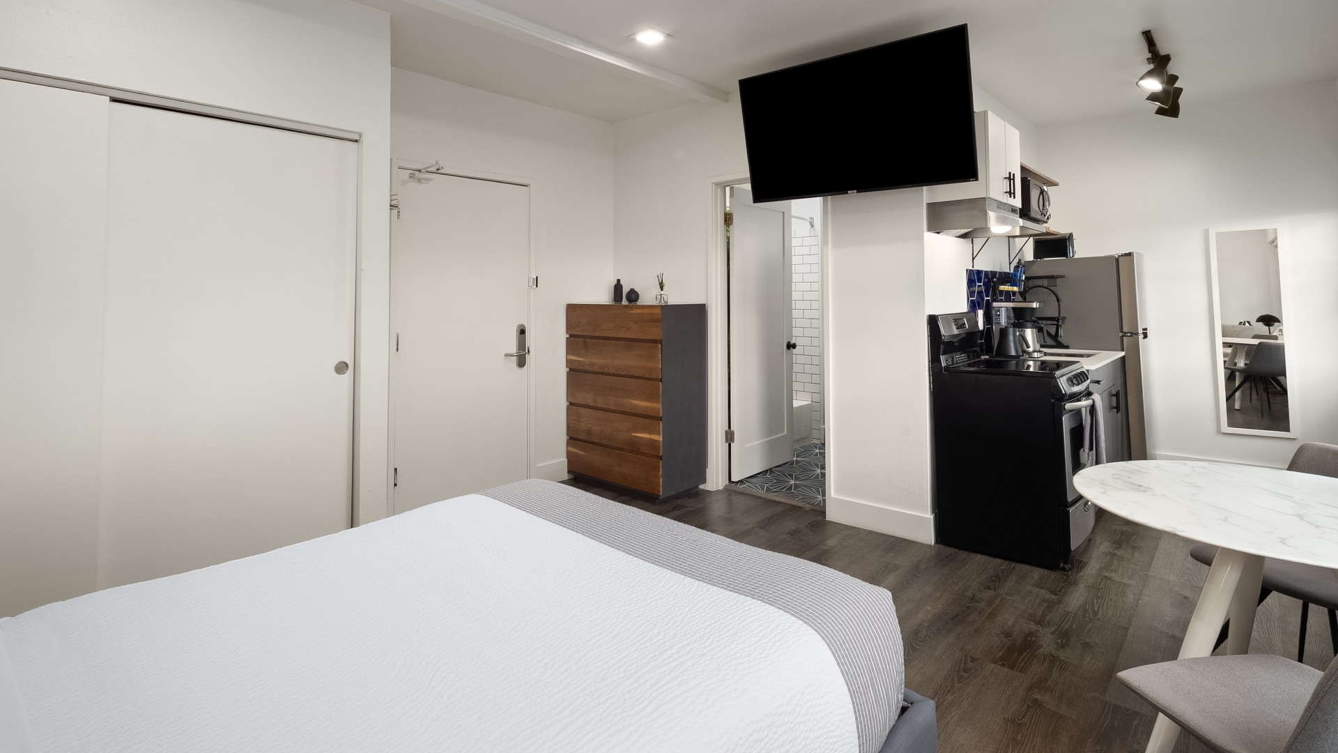 a bedroom with a tv and a cabinet