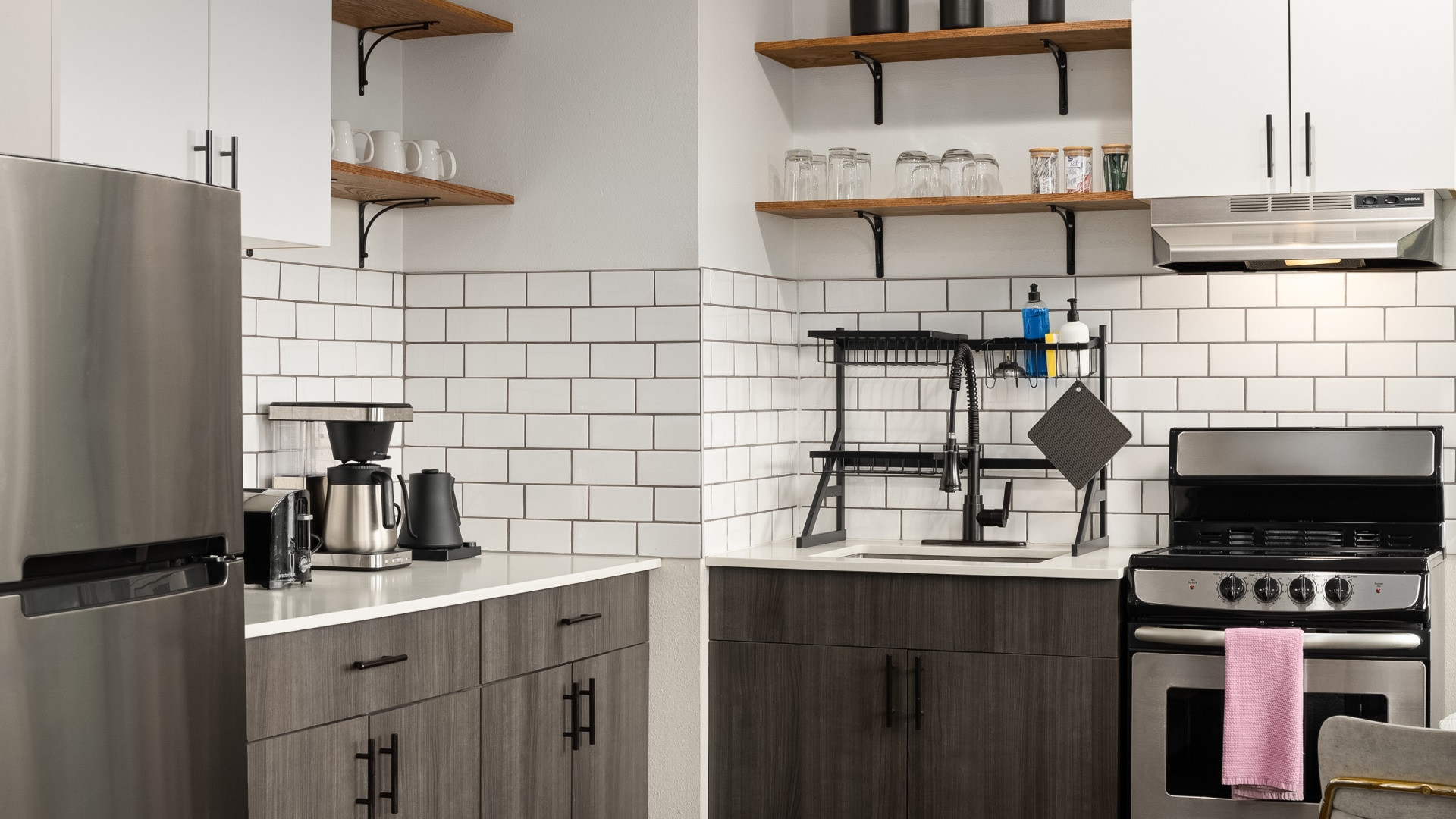 a kitchen with white tile walls and a sink