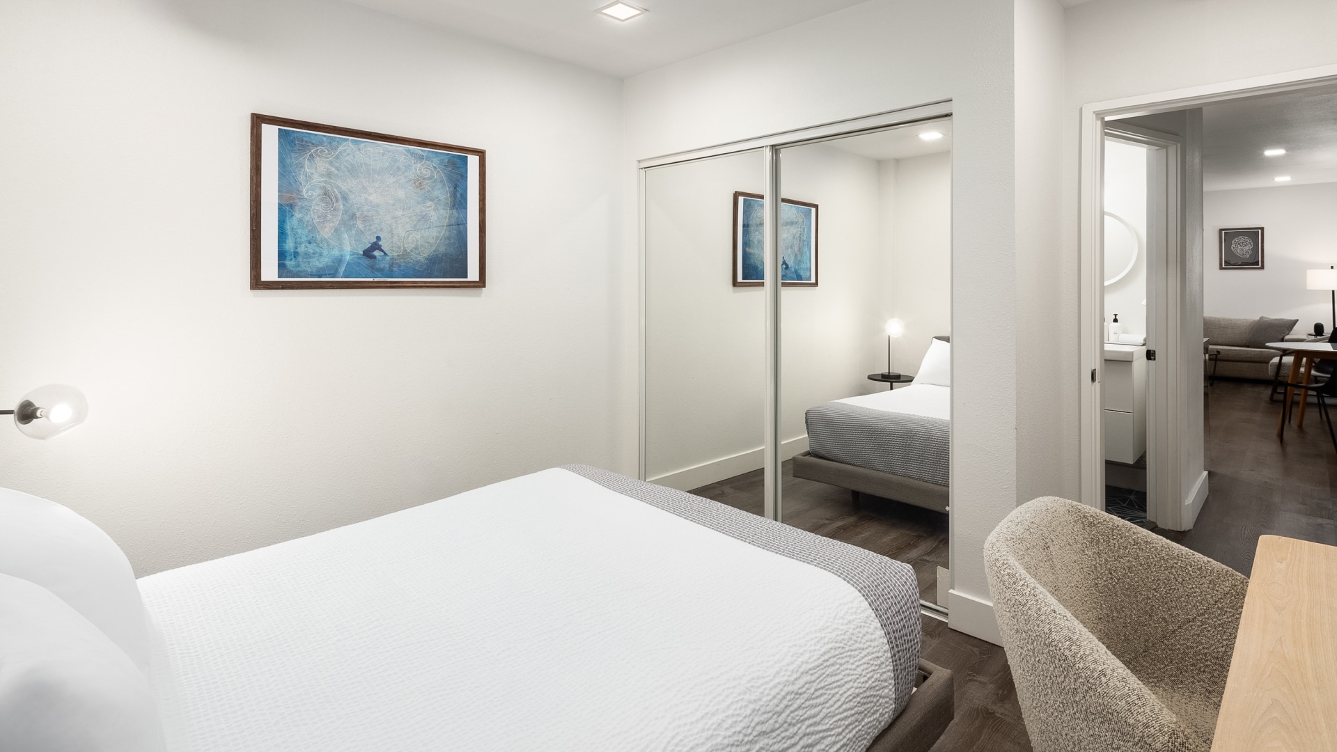 a bedroom with a mirror and bed