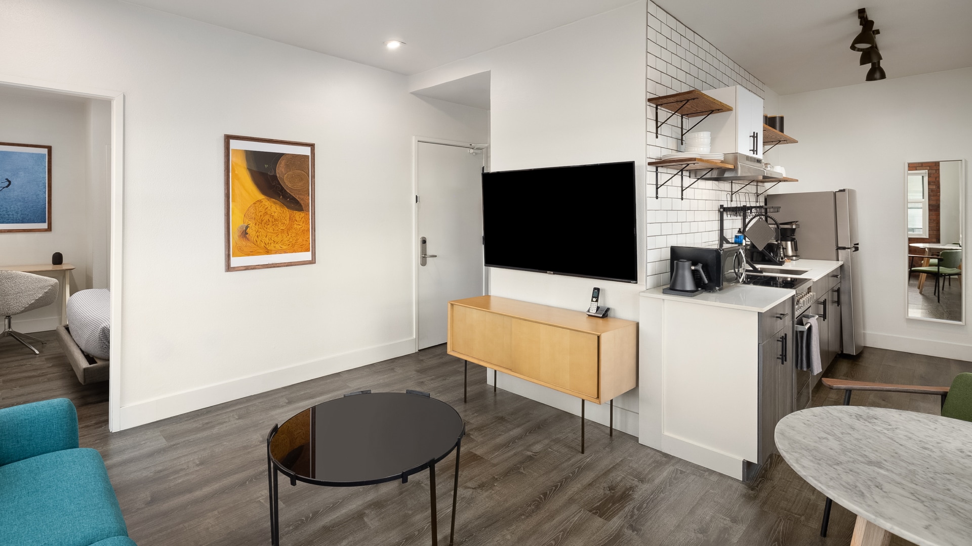 a room with a tv and a sink
