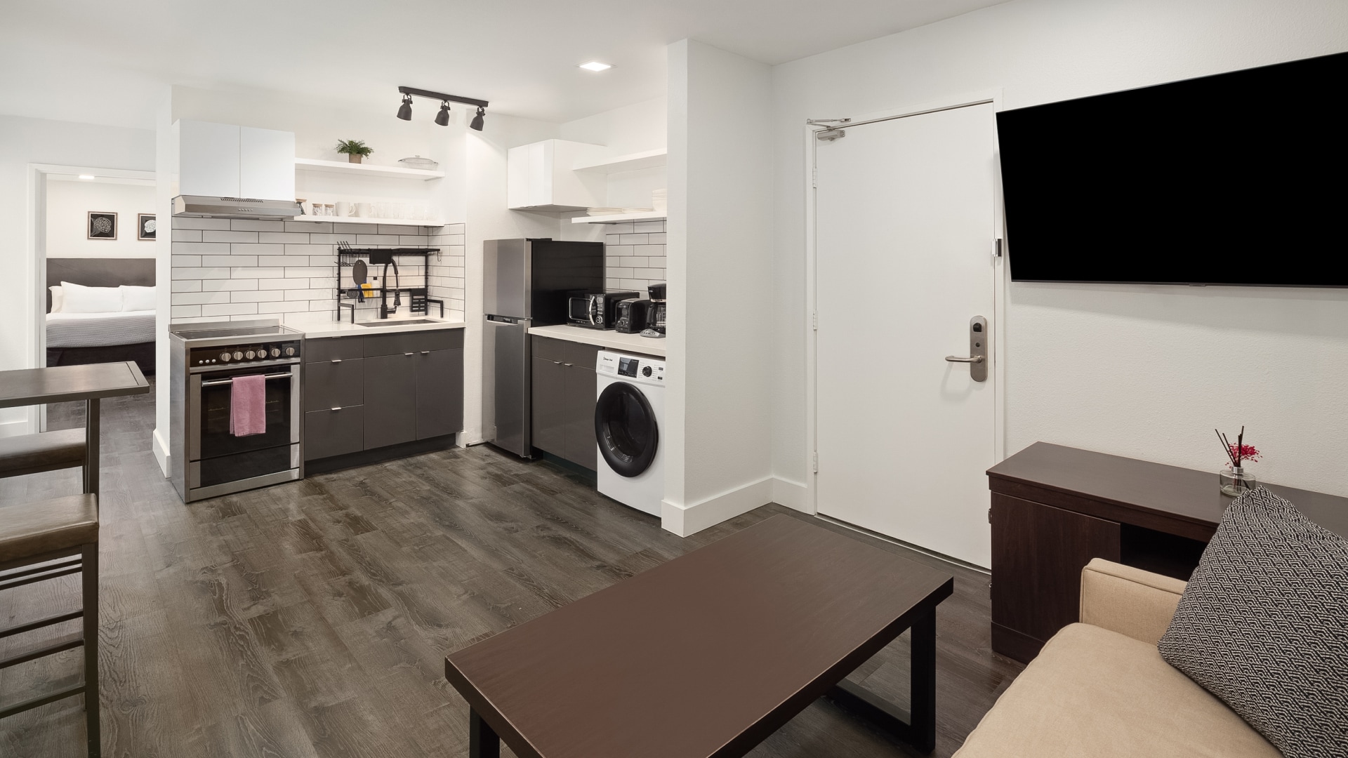 a room with a white door and a white refrigerator