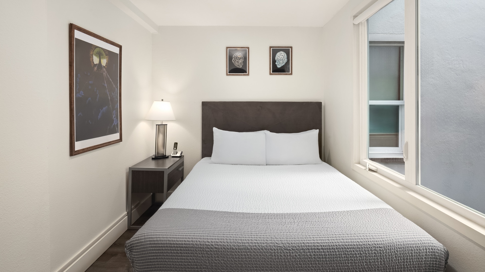 a bed with a lamp and a table