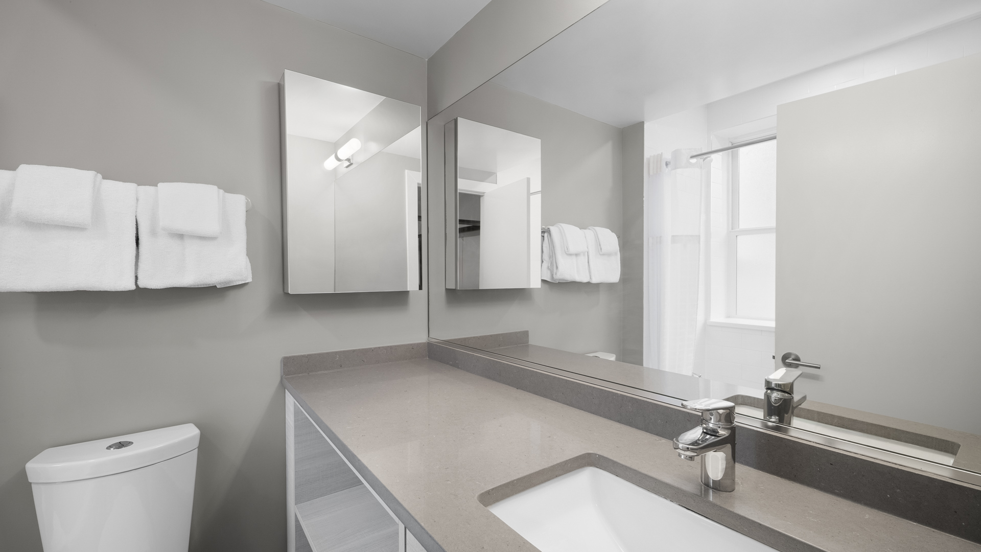 a bathroom with a sink and mirrors