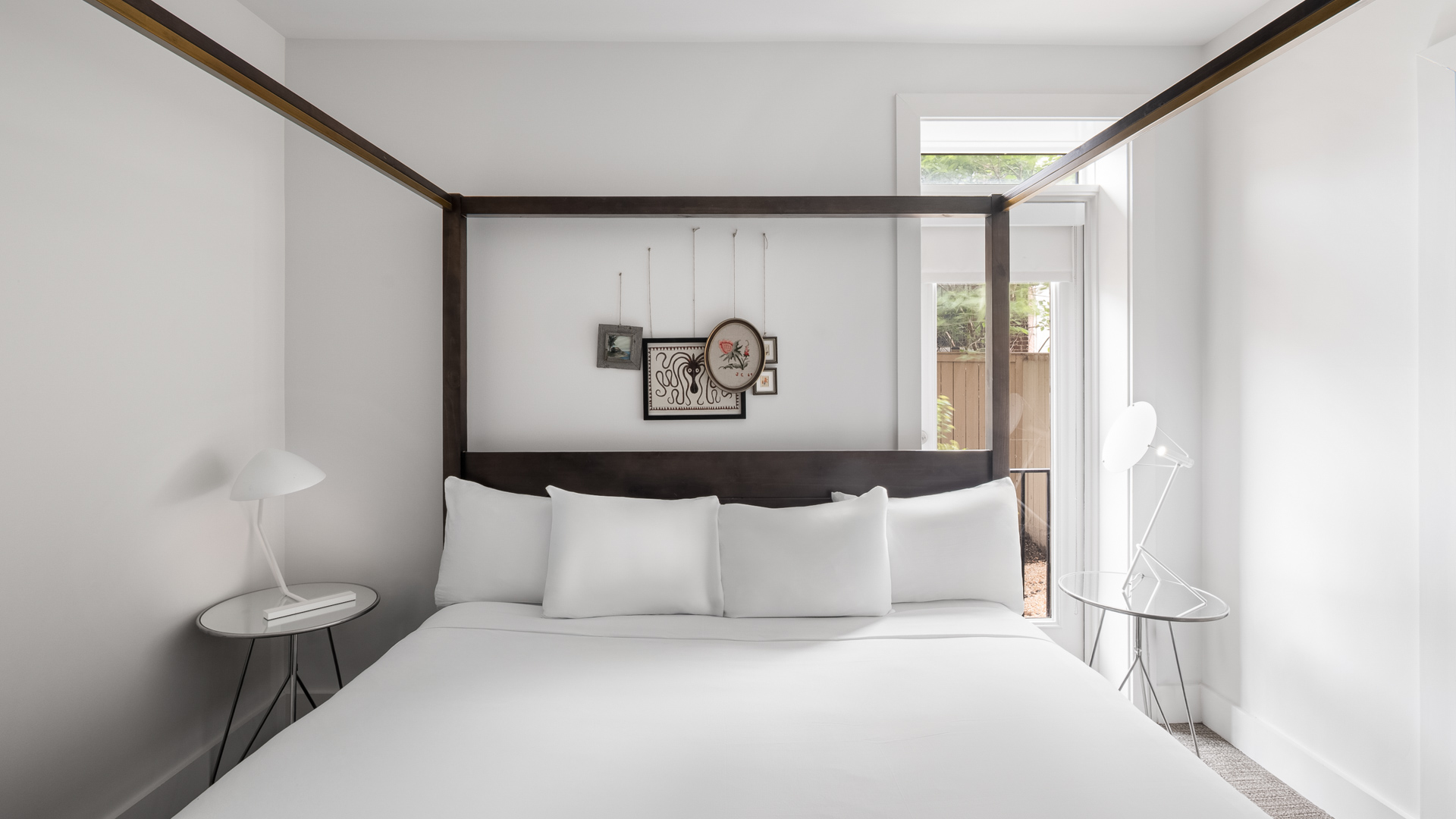 a bed with white sheets and a lamp