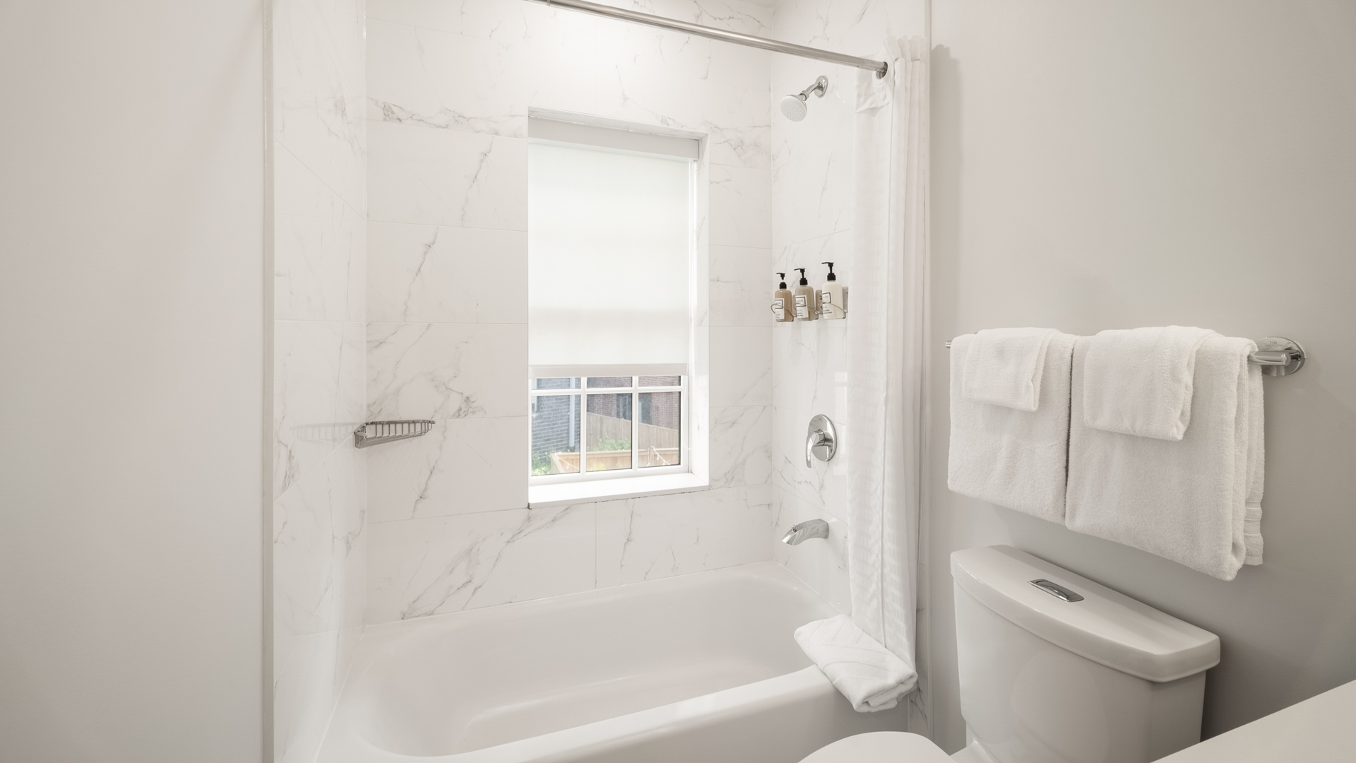 a bathroom with a white bathtub and toilet