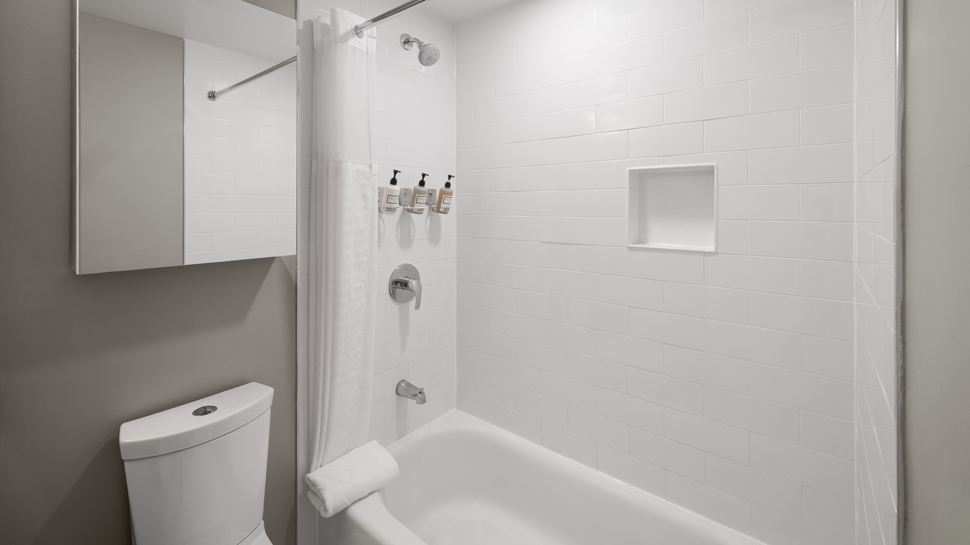 a bathroom with a white shower curtain and tub