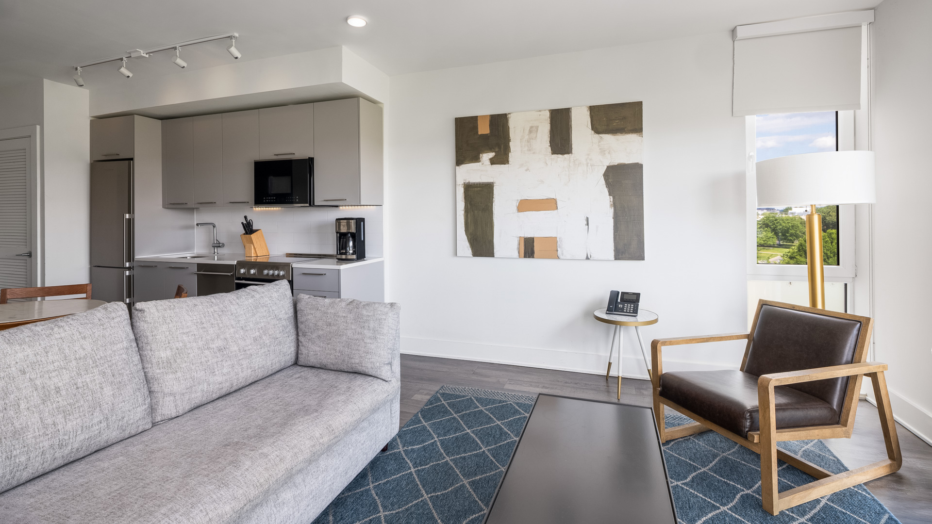a living room with a couch and a kitchen
