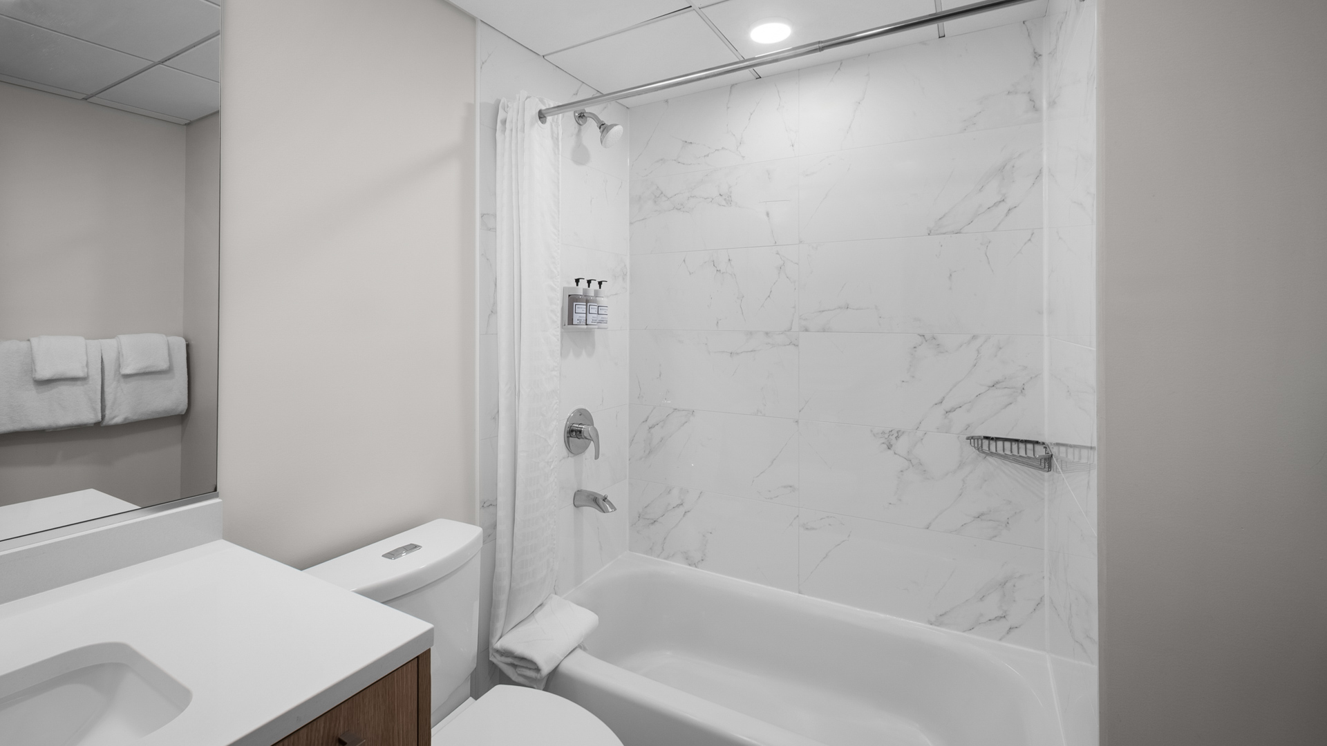 a bathroom with a white bathtub and toilet