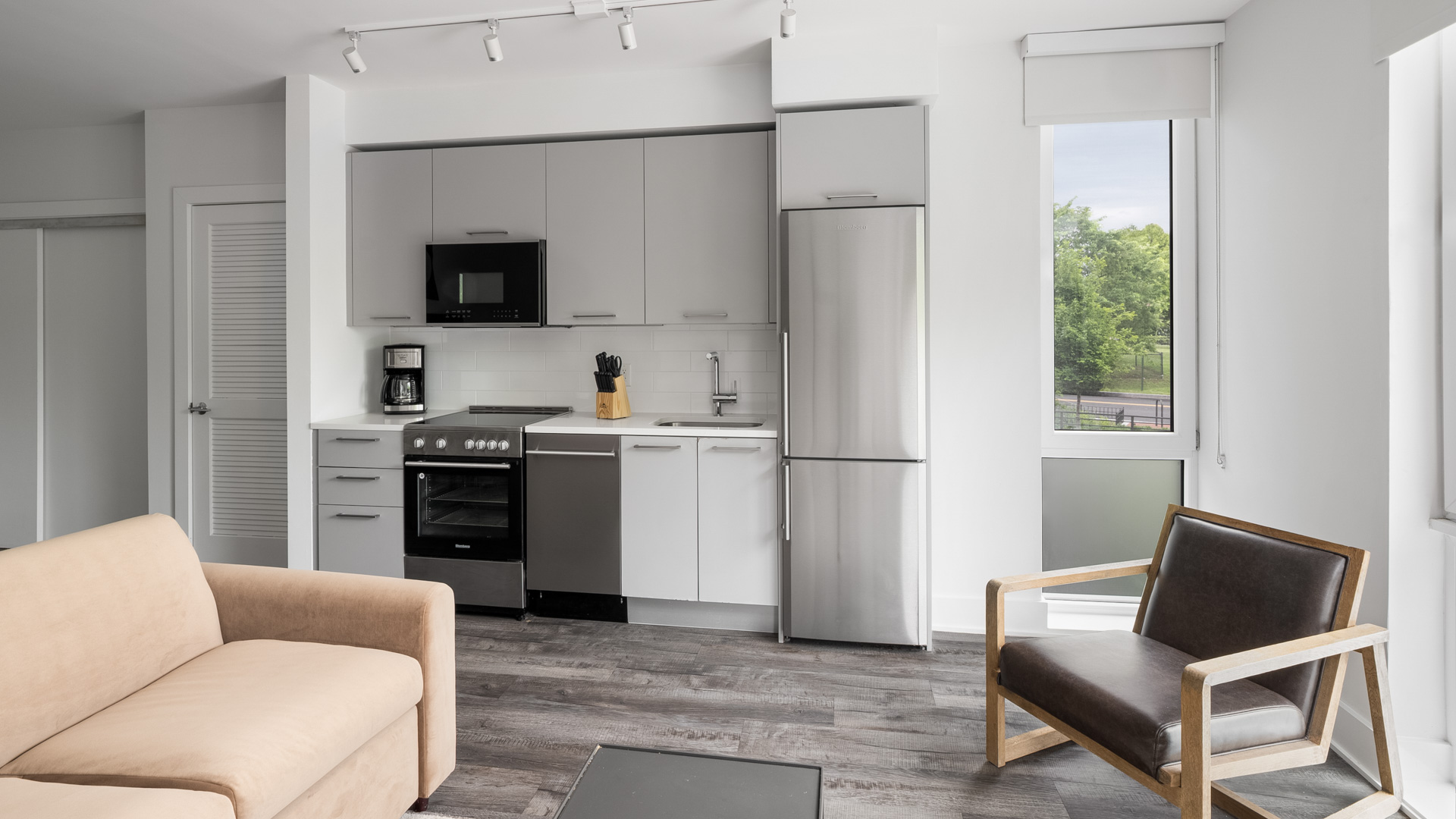 a kitchen with a couch and a chair