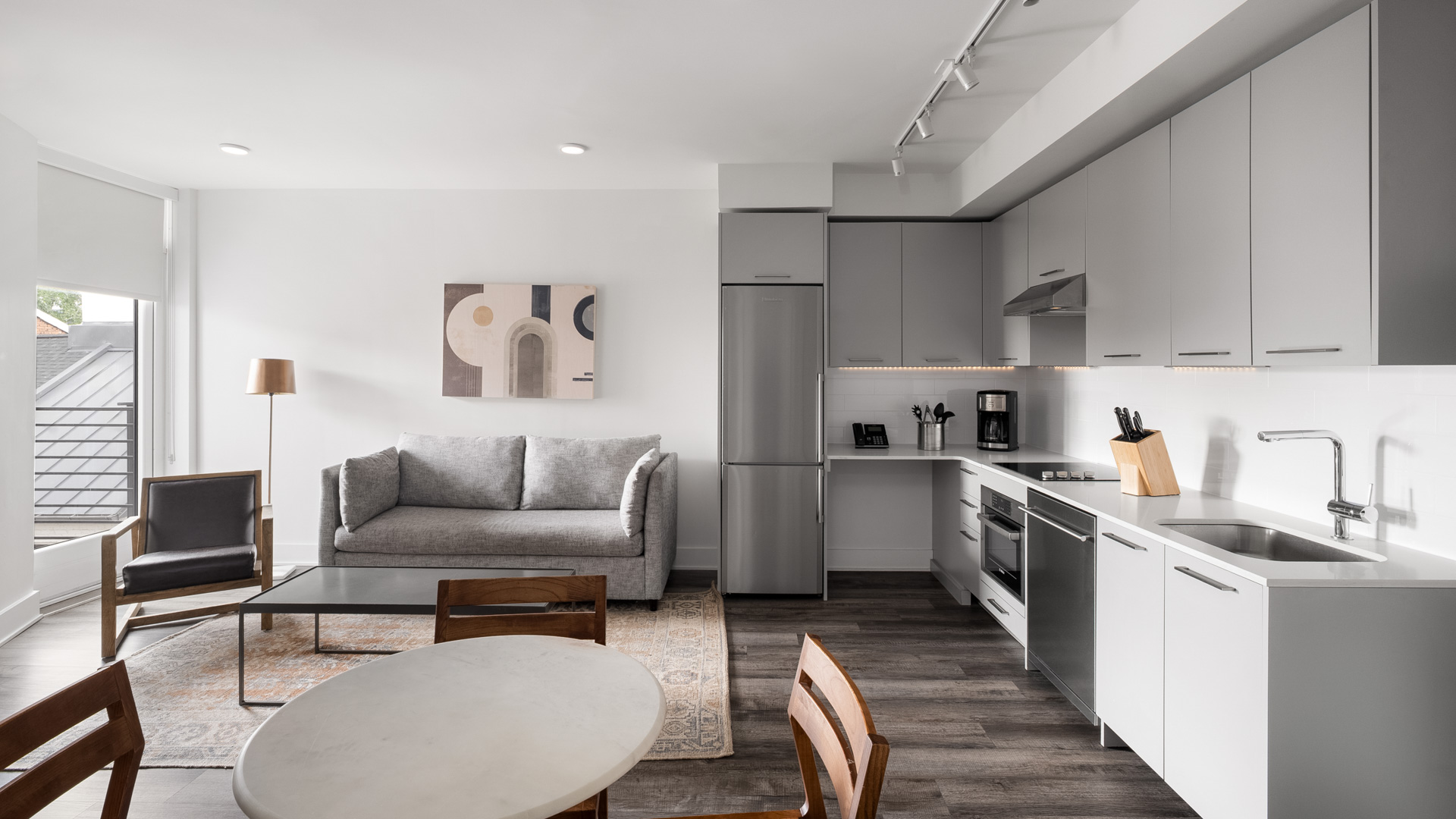 a kitchen and living room with a couch and a table