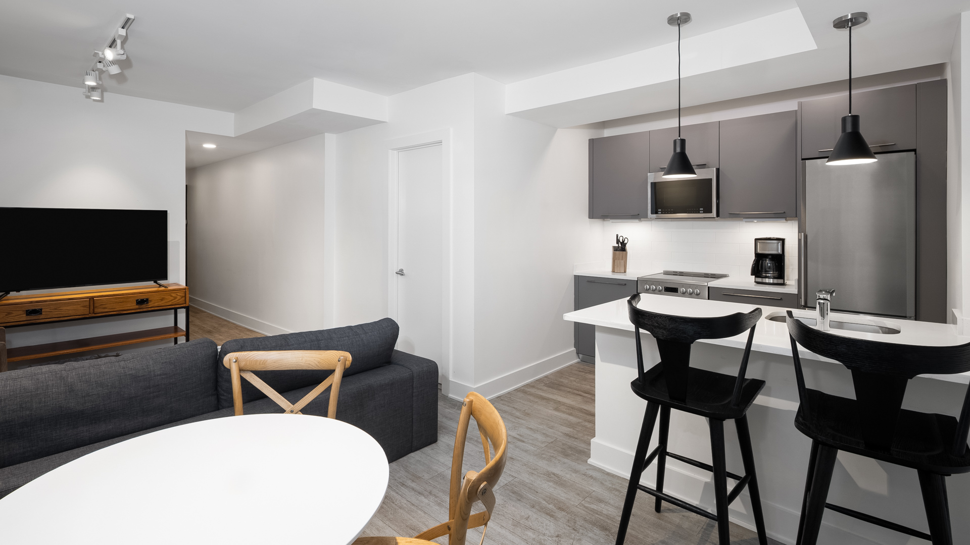 a kitchen and living room with a couch and a table