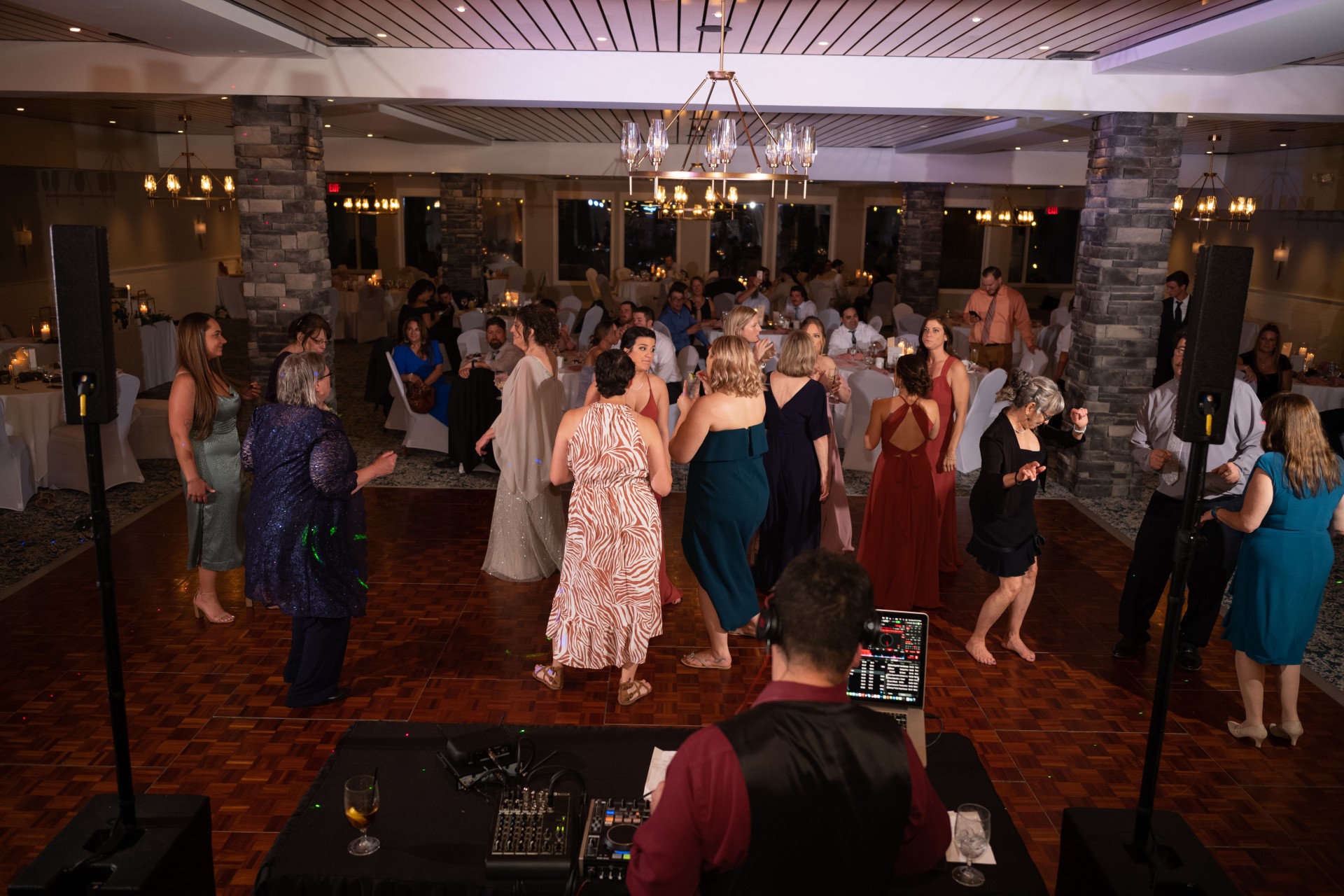 a group of people dancing in a room with a crowd of people