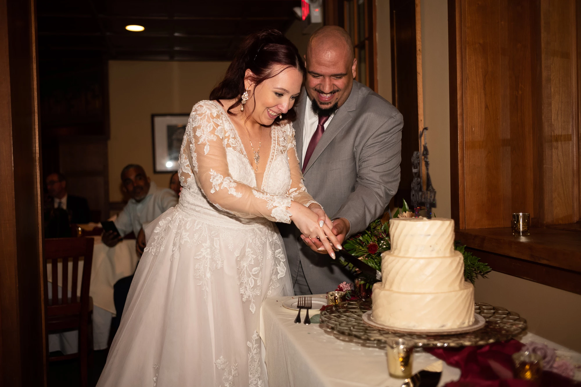 a man and woman cutting a cake