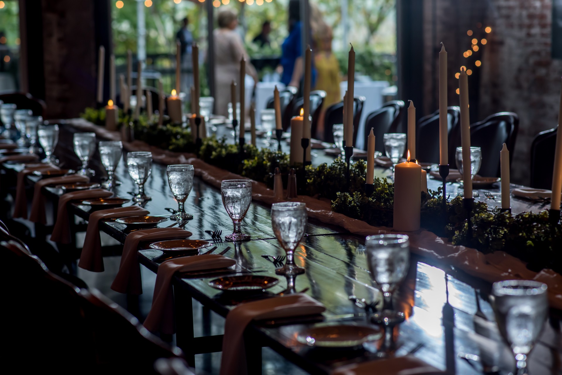 a long table with wine glasses and candles