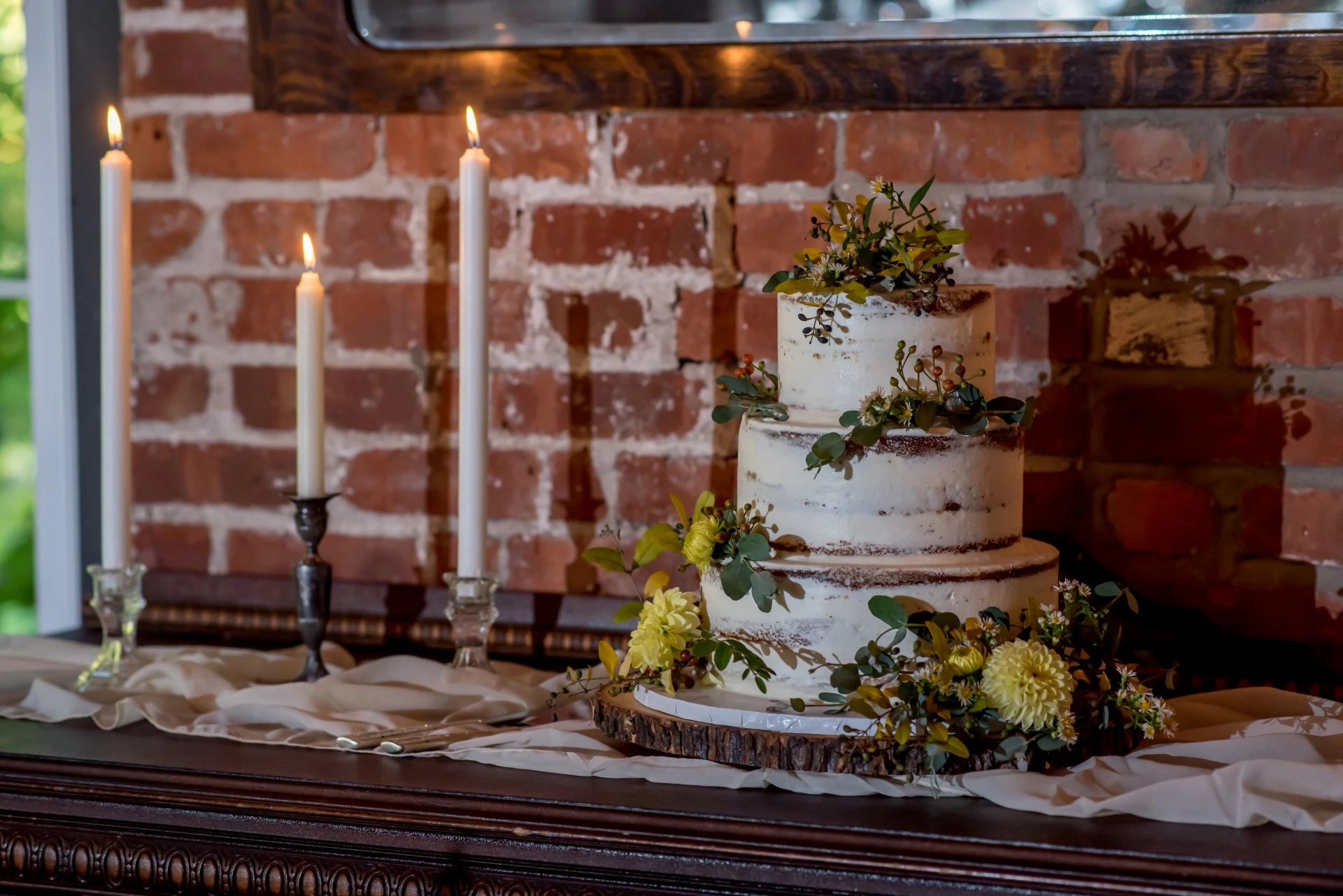 a cake with flowers and candles on a table