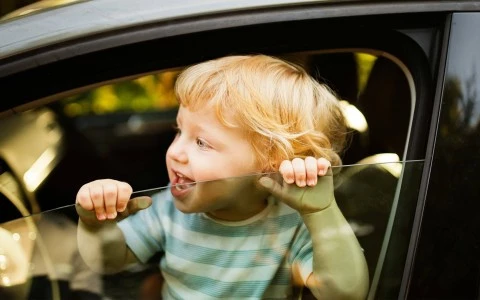 a child looking out a car window