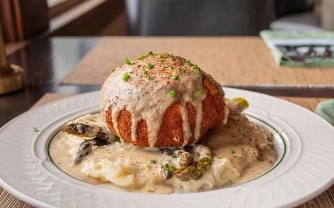 a plate of food with a round object on top