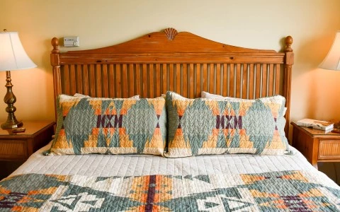a bed with pillows and a blanket