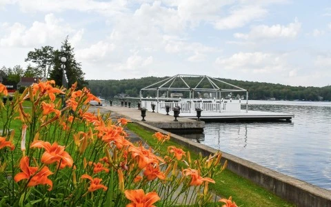 a dock with orange flowers and a white structure