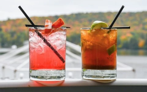 two glasses with liquid and straws
