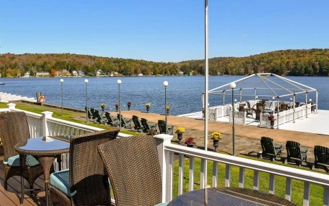 a deck with chairs and a lake