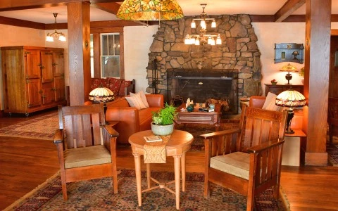 a living room with a fireplace and chairs