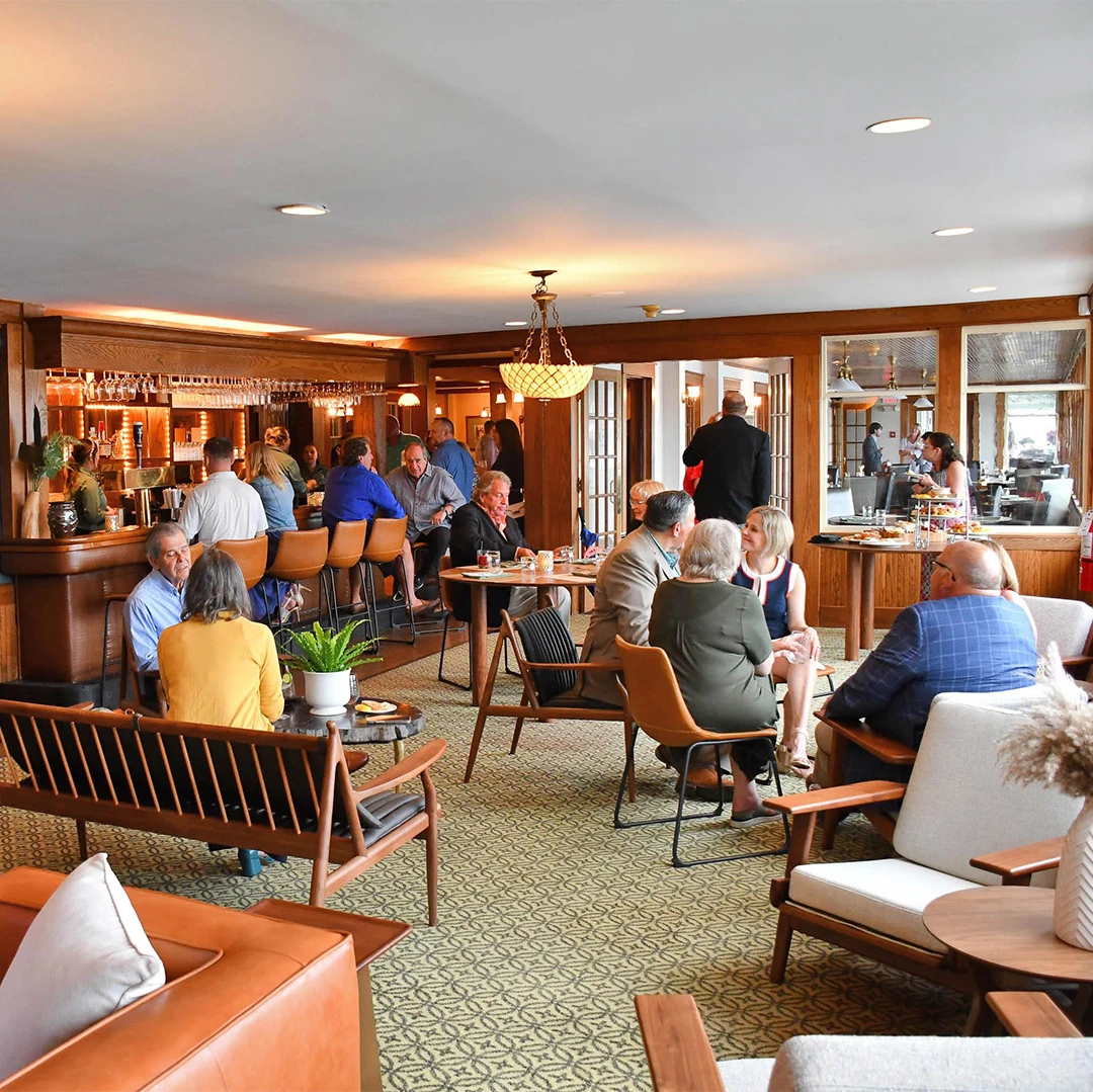 a group of people sitting around tables in a room