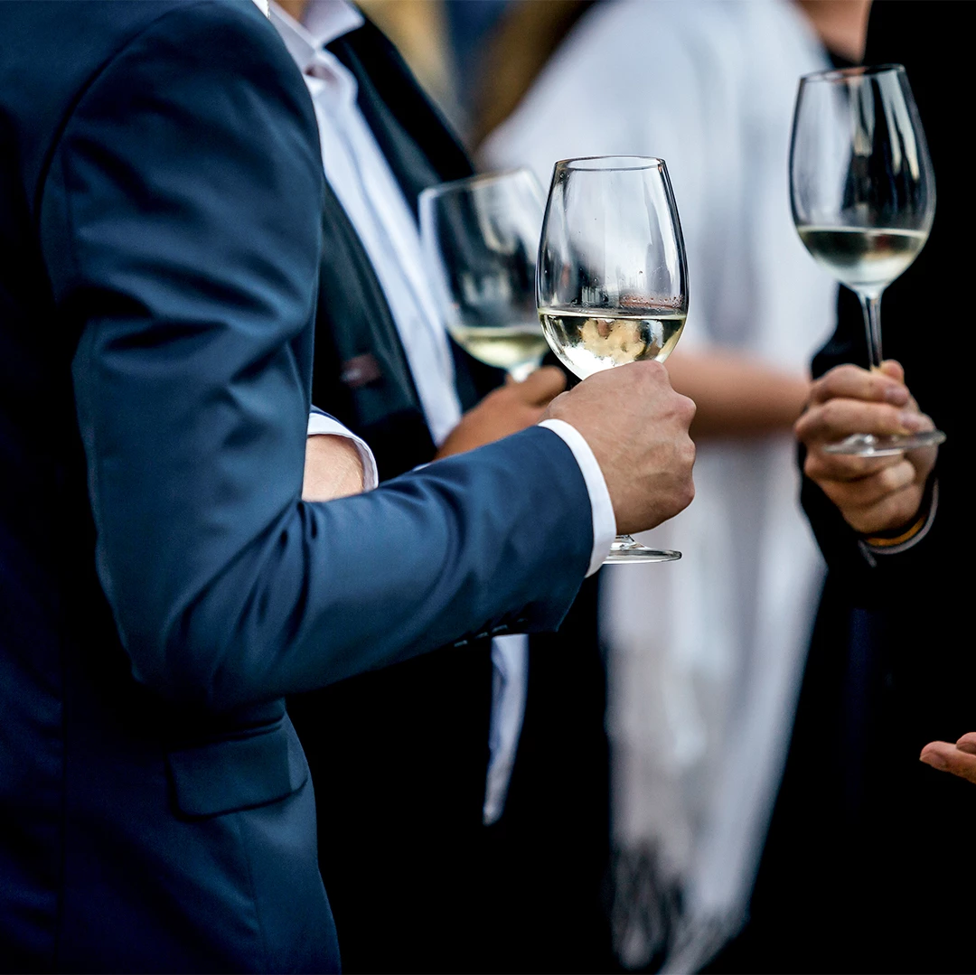 a group of people holding wine glasses