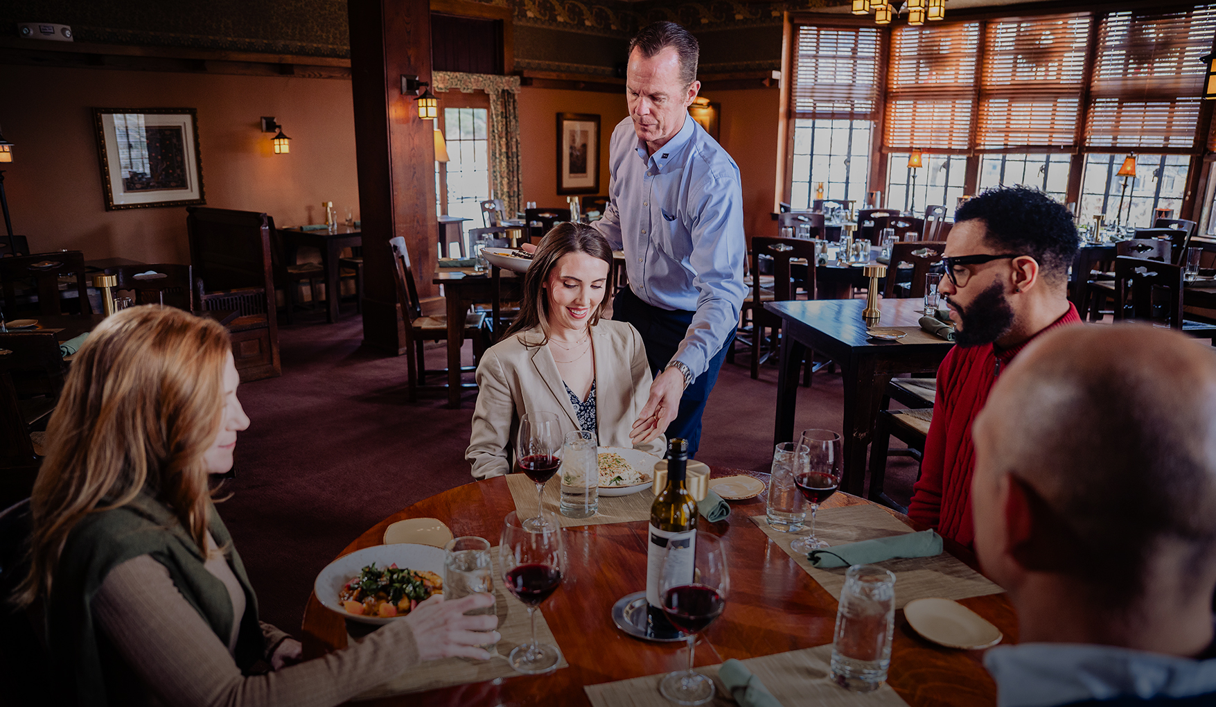 a man serving a woman at a table