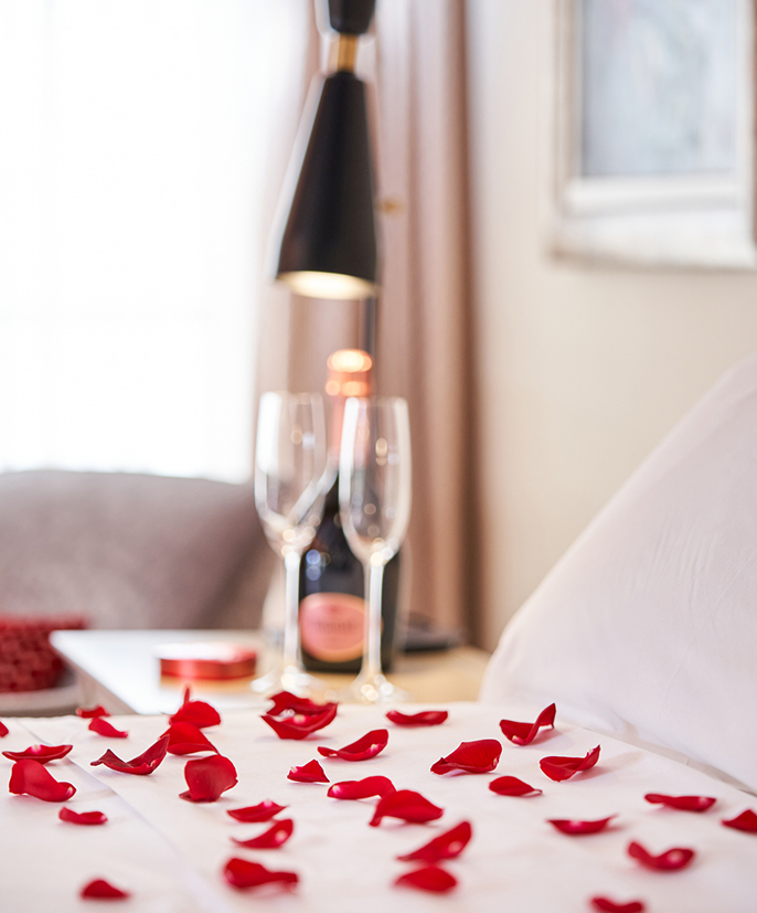 a bed with rose petals on it