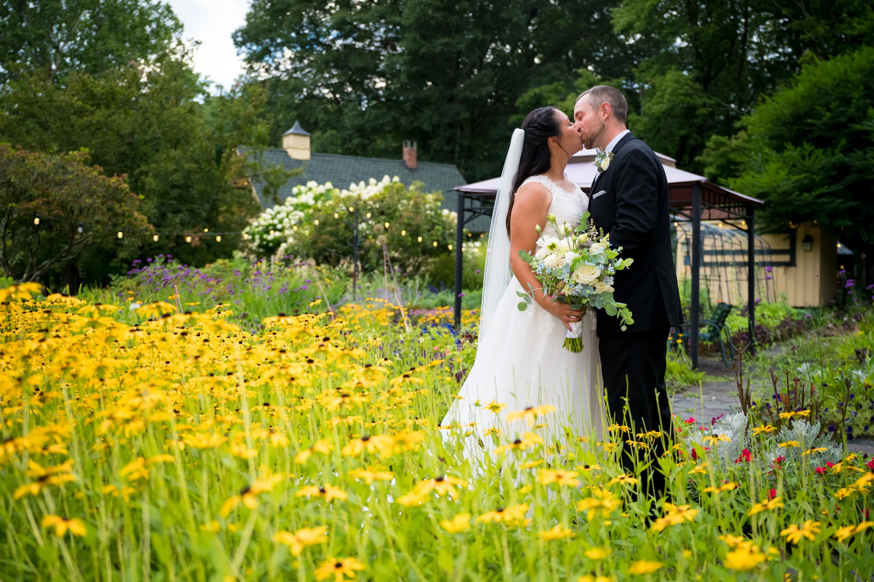 a man and woman kissing in a garden