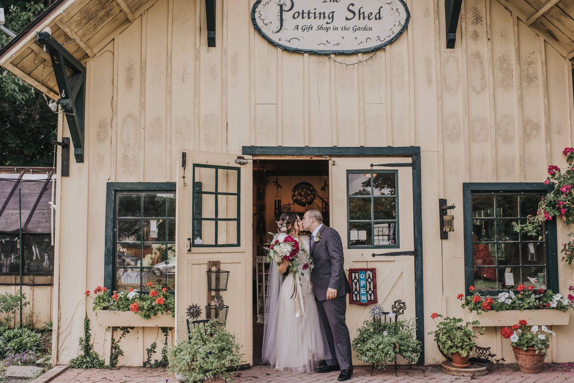 a man and woman kissing in front of a building