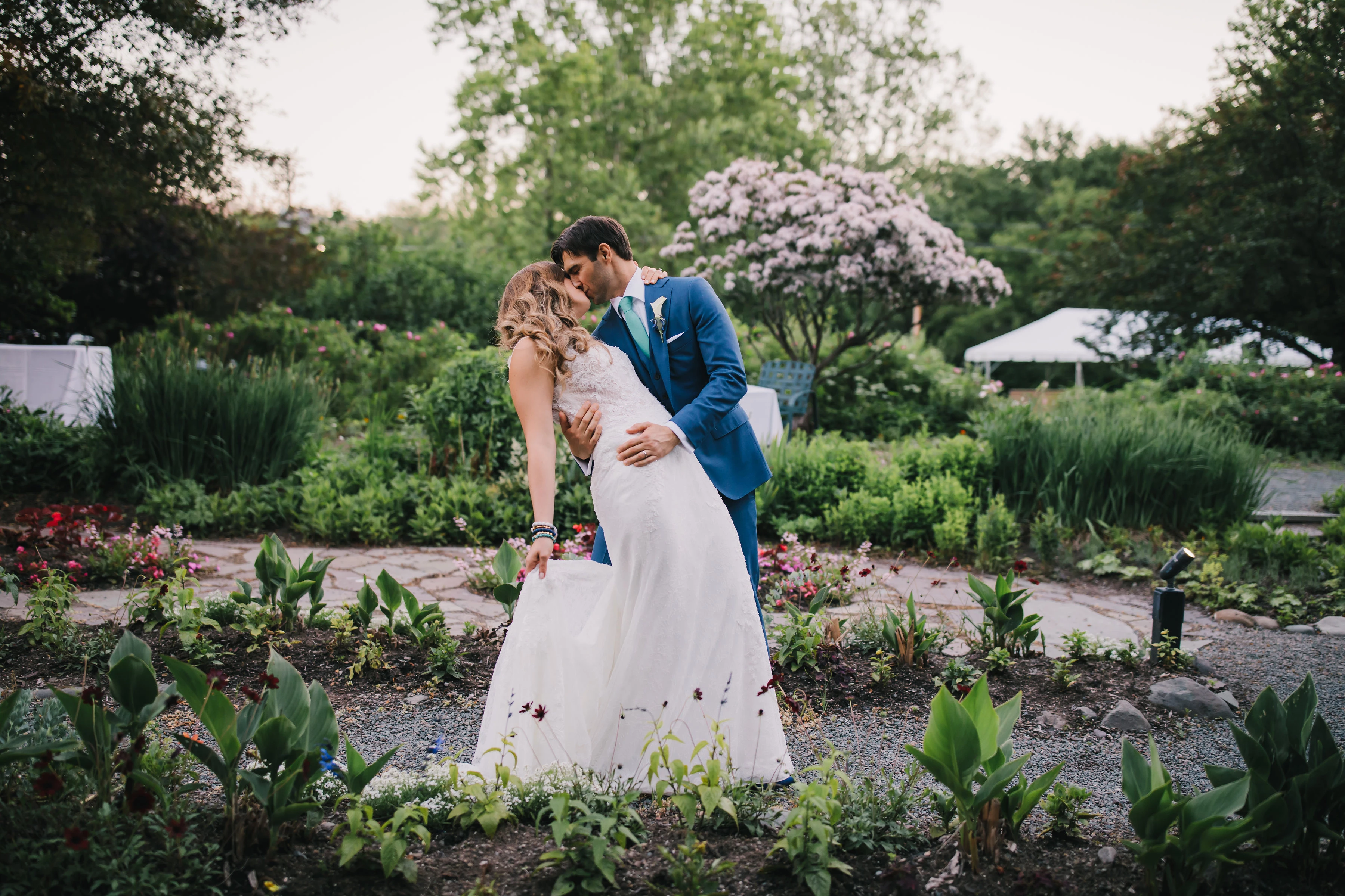 a man and woman kissing in a garden