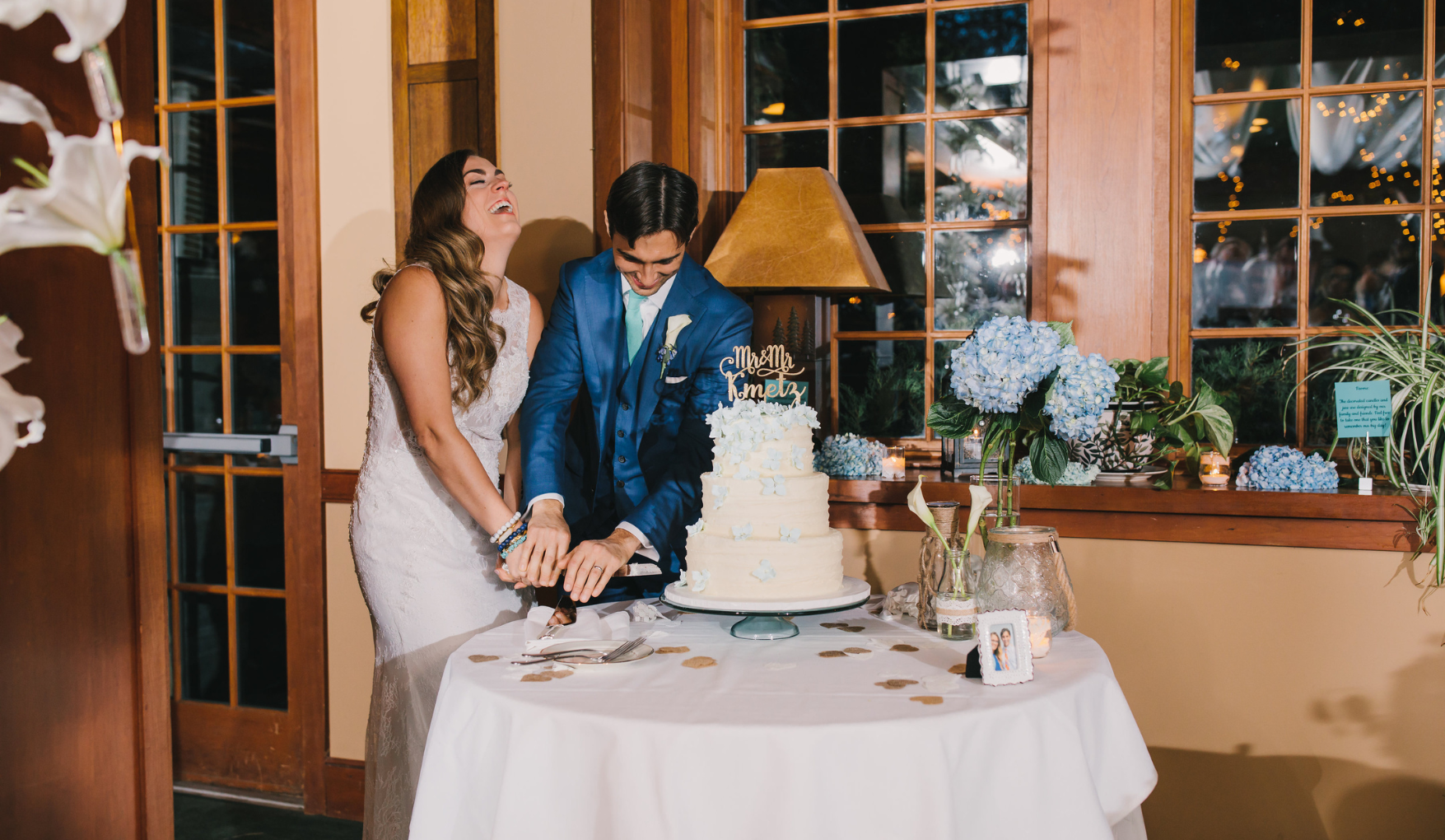 a man and woman cutting a cake
