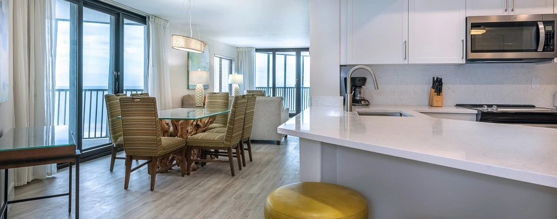 a kitchen and dining area with a table and chairs
