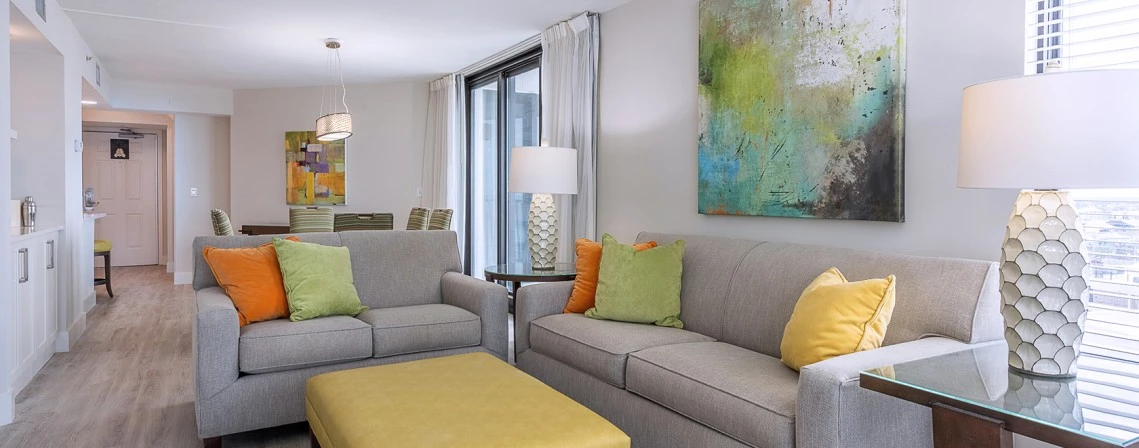 a living room with couches and ottoman