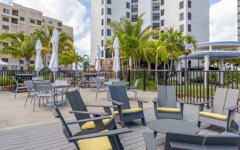 a patio with chairs and umbrellas