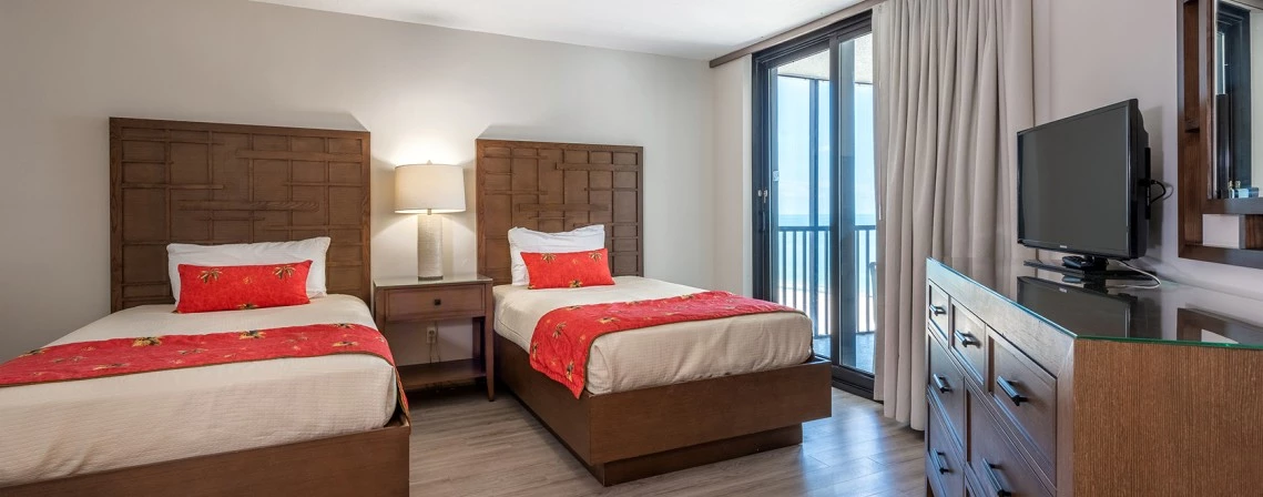 a room with two beds and a television