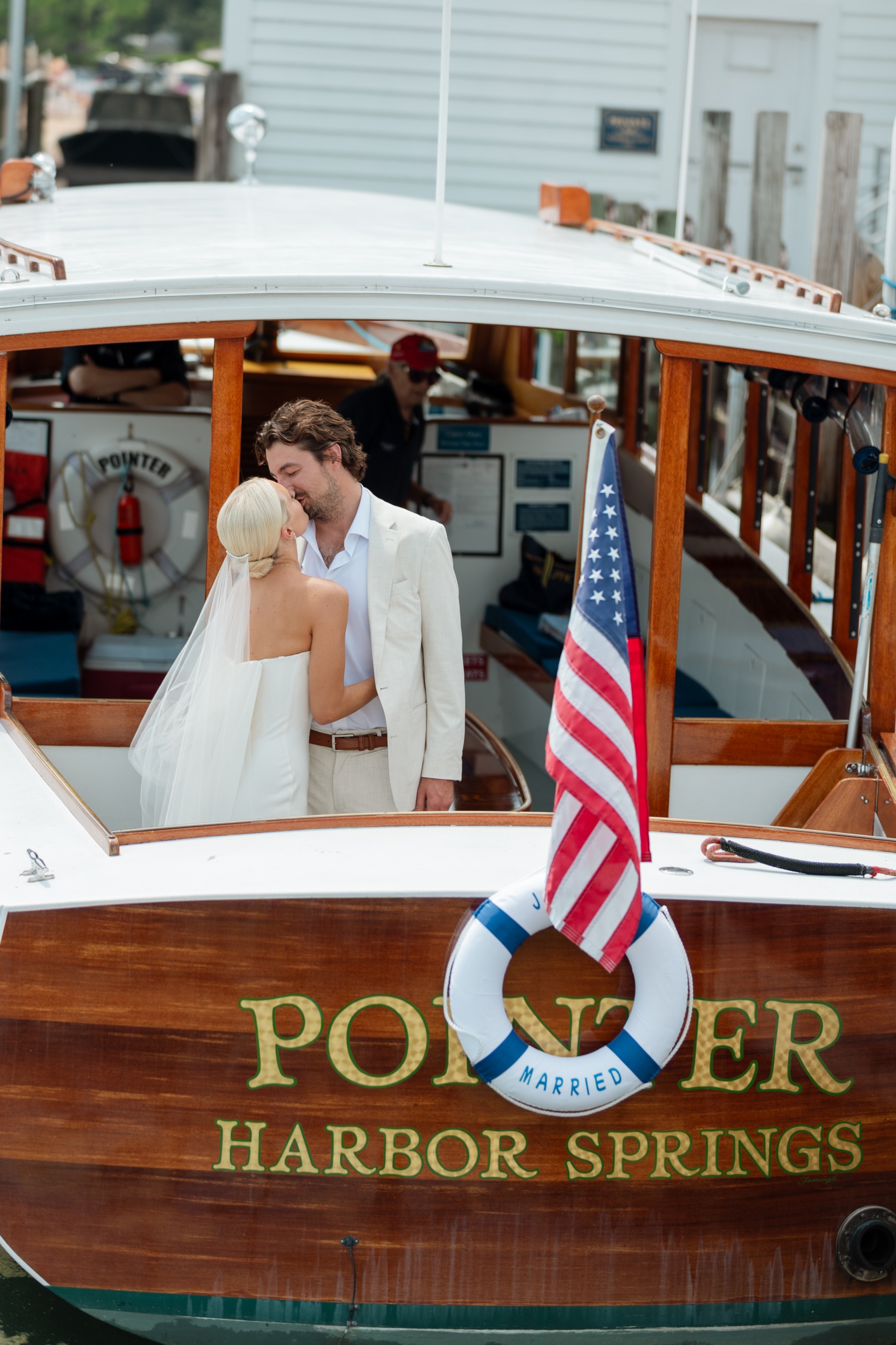 a man and woman kissing on a boat