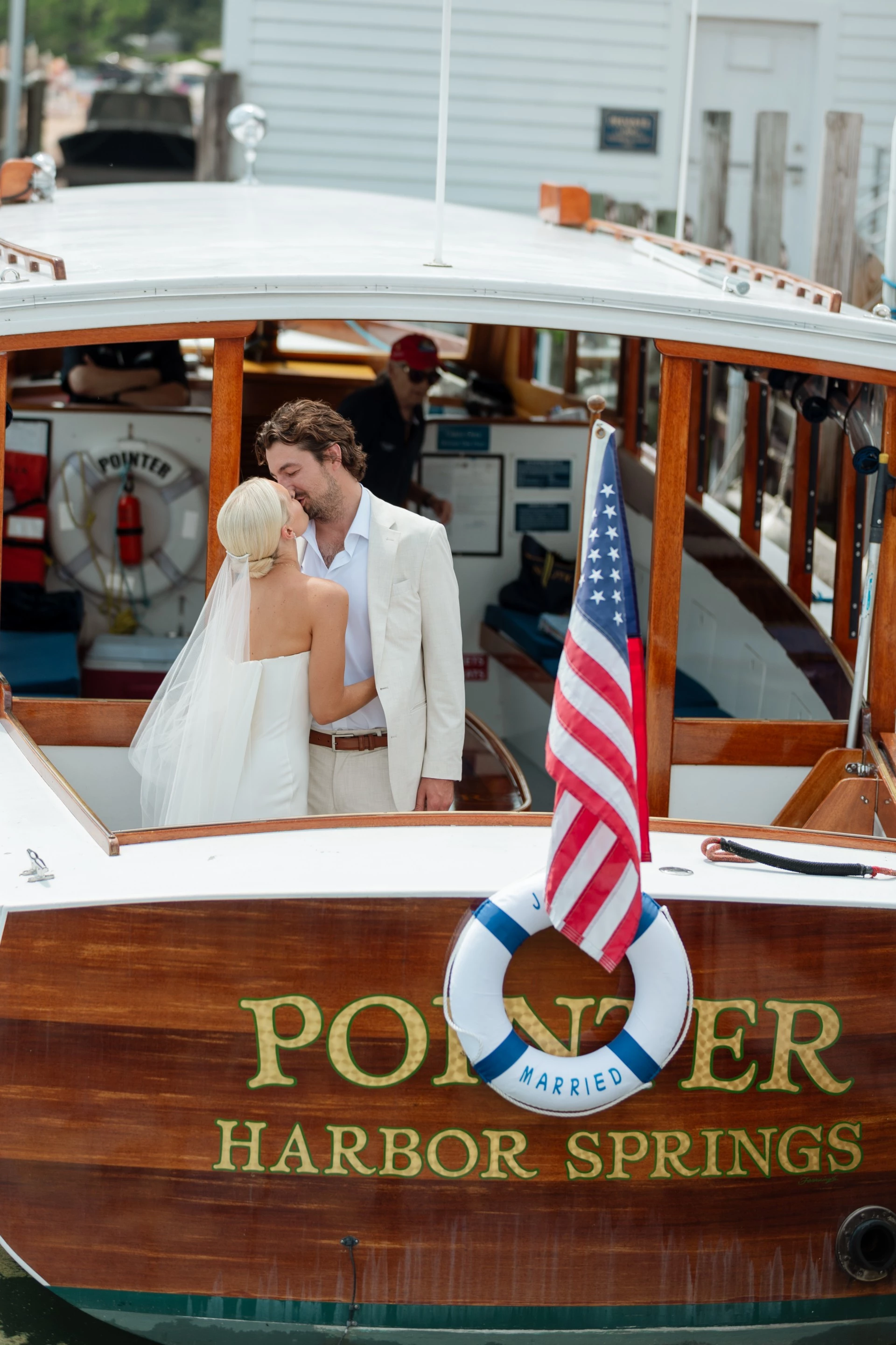 a man and woman kissing on a boat