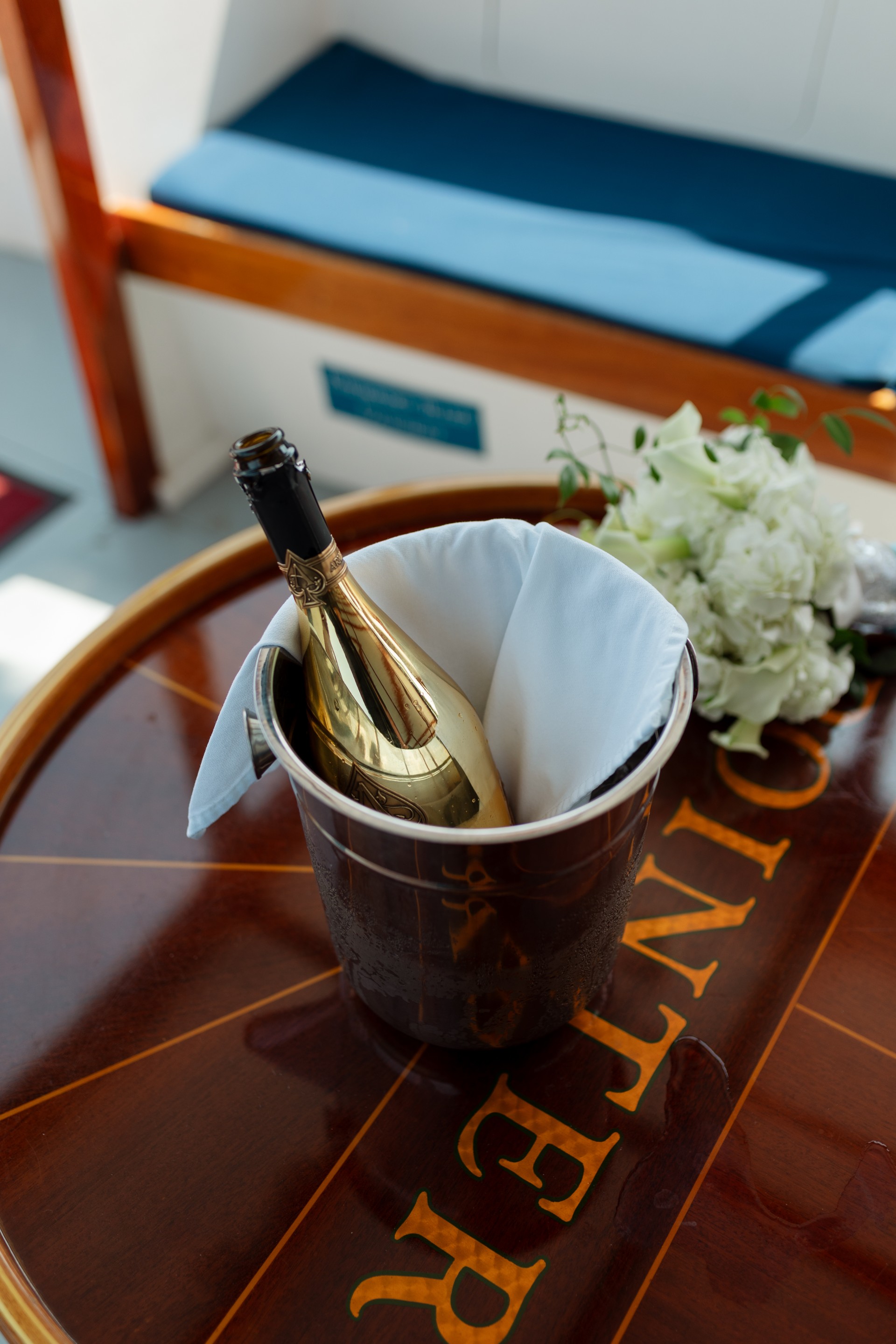 a bottle in a bucket on a table
