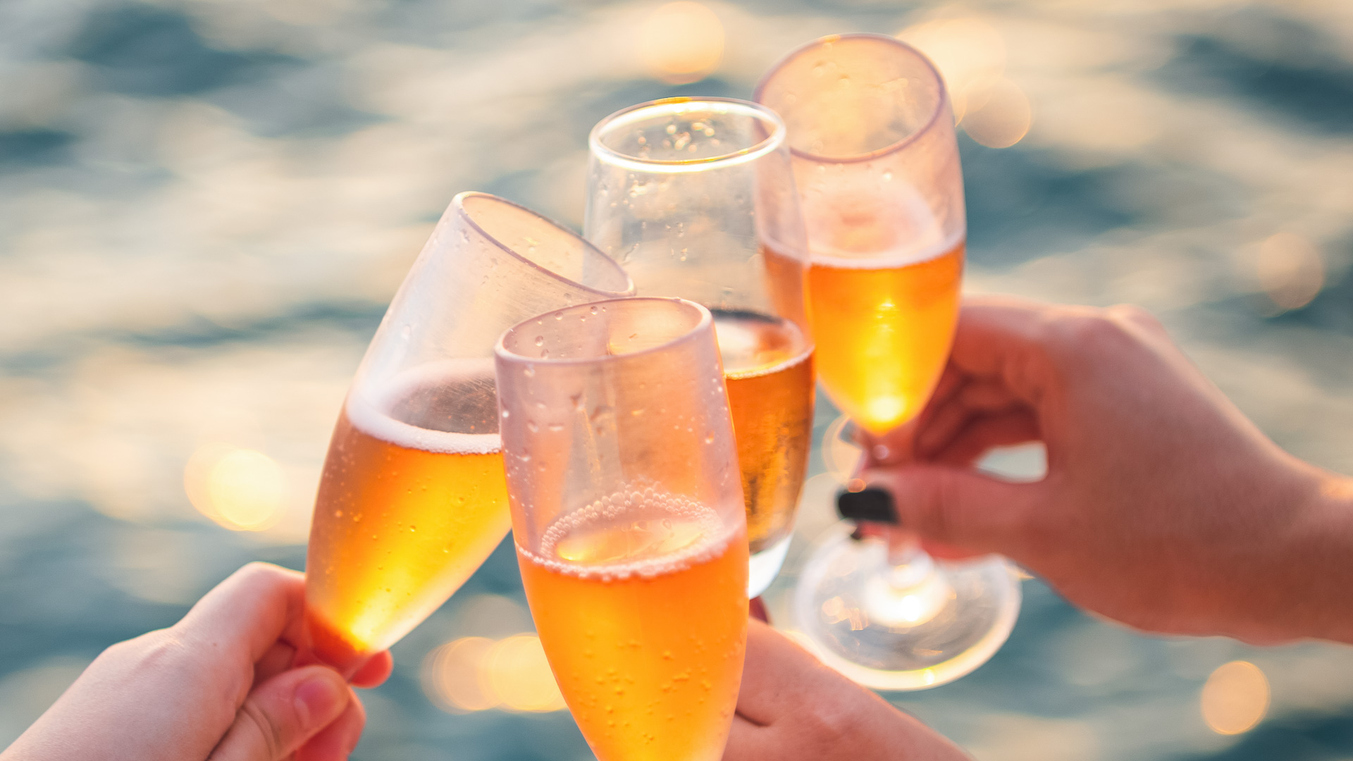 a group of people holding up champagne glasses