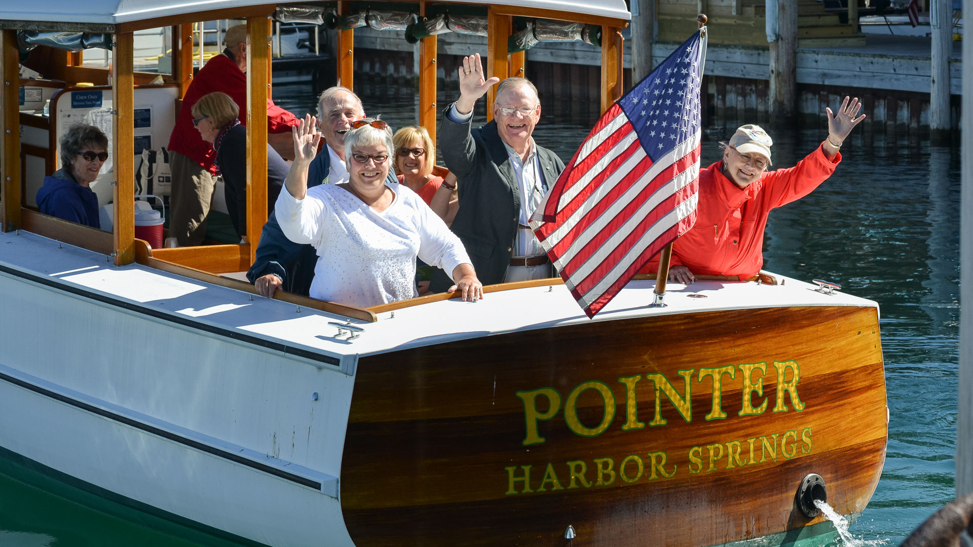 a group of people on a boat waving