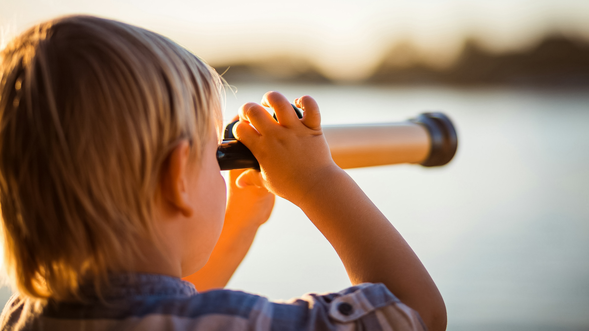 a child looking through a telescope
