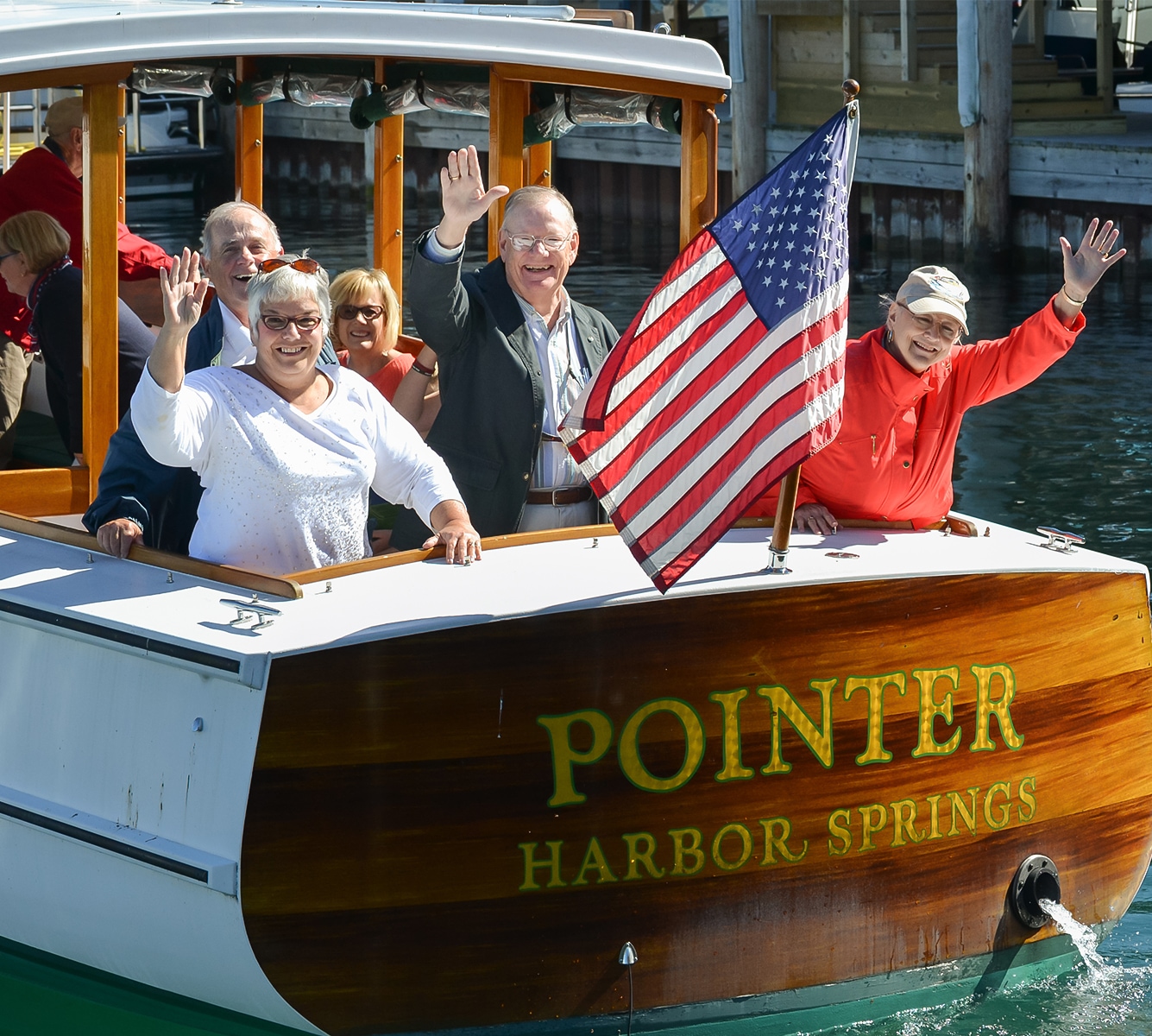 a group of people on a boat waving