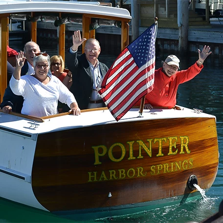 a group of people on a boat waving