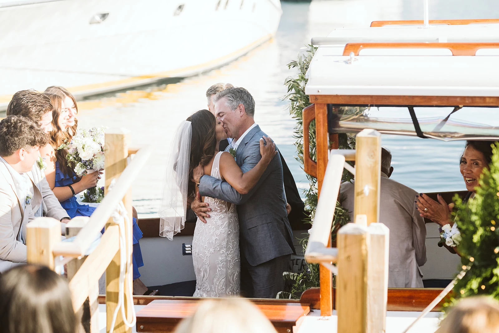 a man and woman kissing on a boat